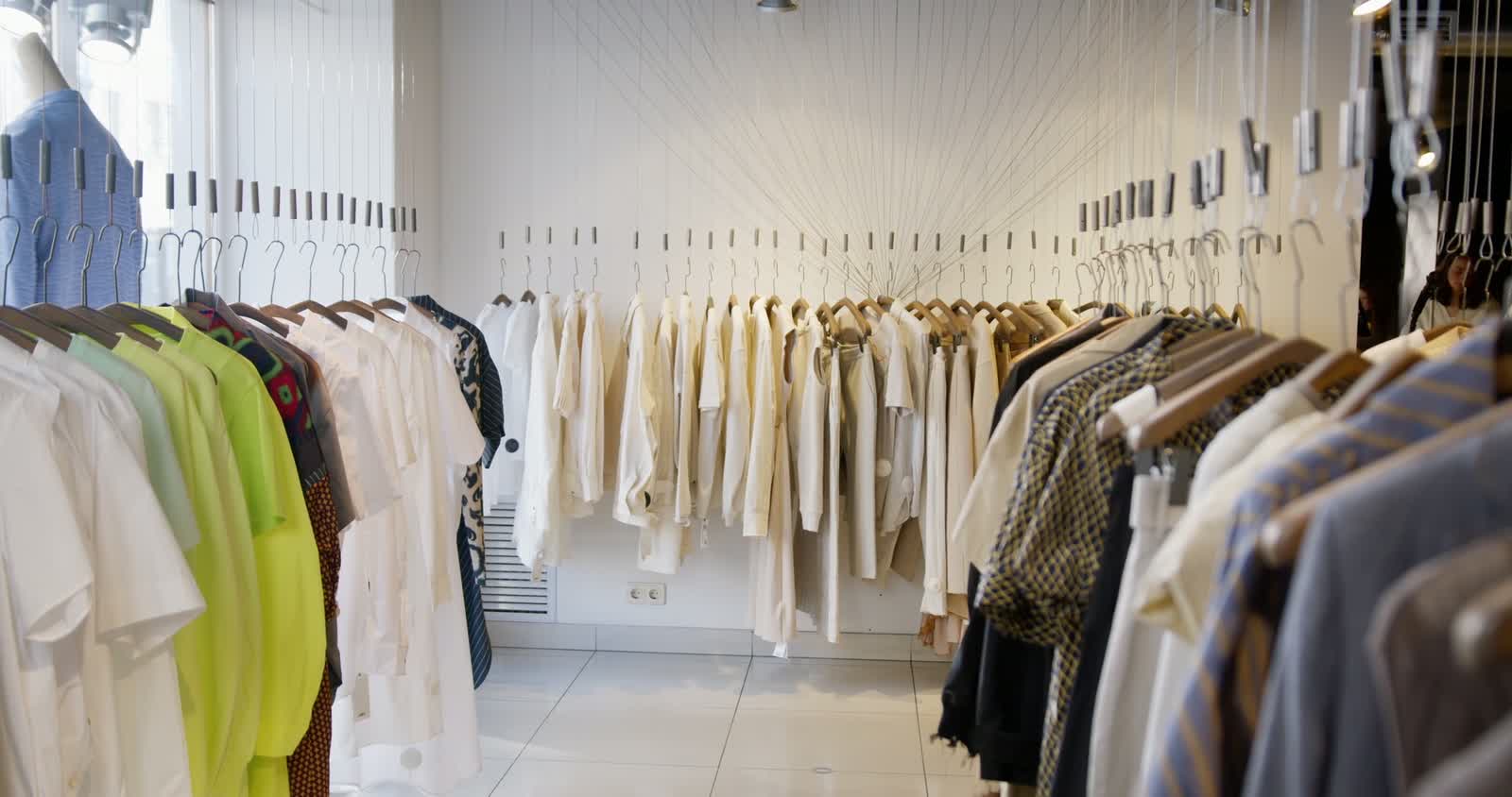 Clothing displayed on rails inside a retail store