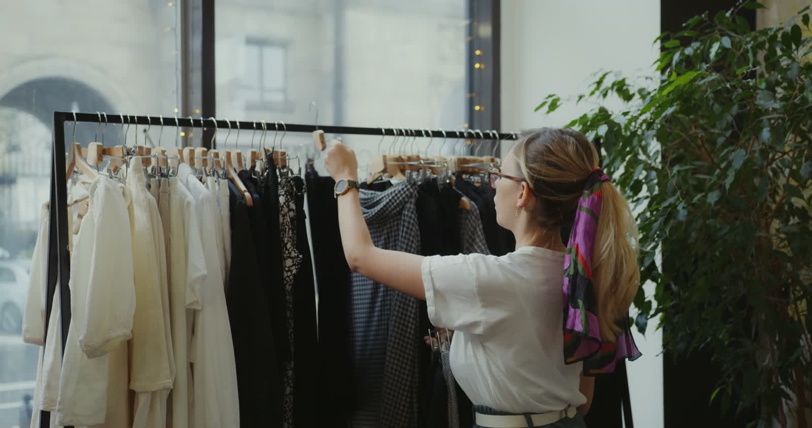 Retail store team member preparing clothing for the sales floor